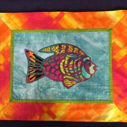 Hand Cut Fused Fish Wall Hanging. Fabric Hanging With Red Backing Fabric. Cutwork Fish Design By Linda Pool