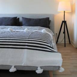 Handmade Moroccan Cotton Blanket With Pom Poms, Black Stripes - thumbnail 3