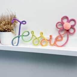 Rainbow Knitted Name Sign Nursery Decor With Flower & Pom-Pom - thumbnail 3