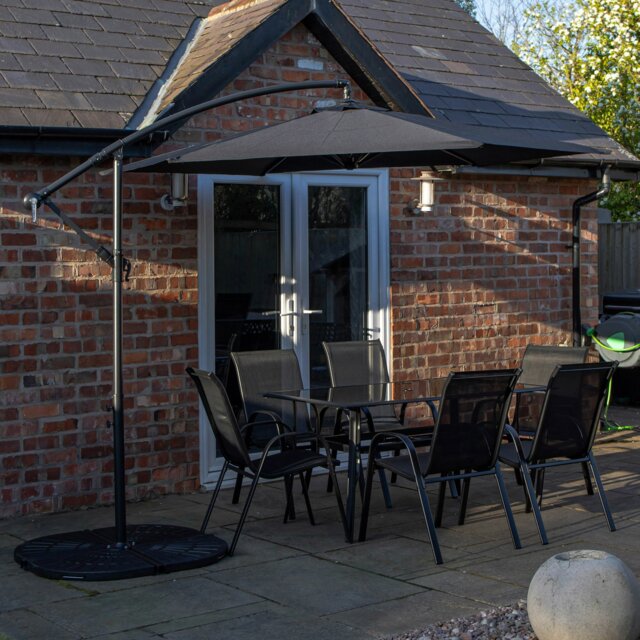 Rackhams Outdoor 6 Person Rectangular Glass Top Garden Dining Table Chairs With Black Banana Parasol and Base - Outdoor Furniture Sets - image 1