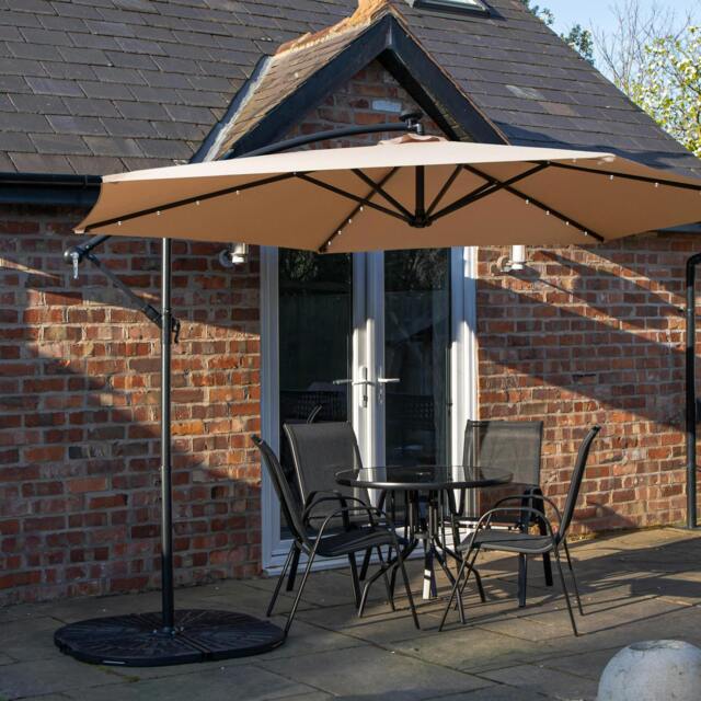 Rackhams Outdoor 4 Person Round Glass Top Garden Dining Table Chairs With Beige Banana Lit Parasol and Base - image 1