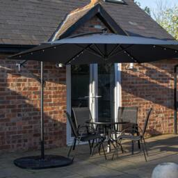Rackhams Outdoor 4 Person Round Glass Top Garden Dining Table Chairs With Blue Banana Lit Parasol and Base