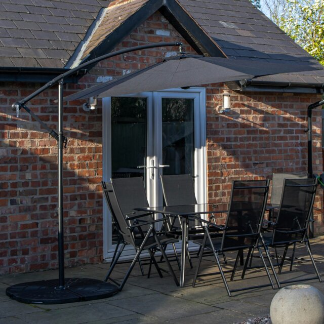 Rackhams Outdoor 6 Person Rectangular Glass Top Garden Dining Table Chairs With Black Banana Parasol and Base - Outdoor Furniture Sets - image 1