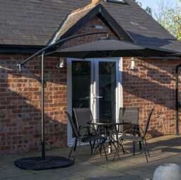 Rackhams Outdoor 4 Person Round Glass Top Garden Dining Table Chairs With Black Banana Parasol and Base - Outdoor Furniture Sets - thumbnail 1