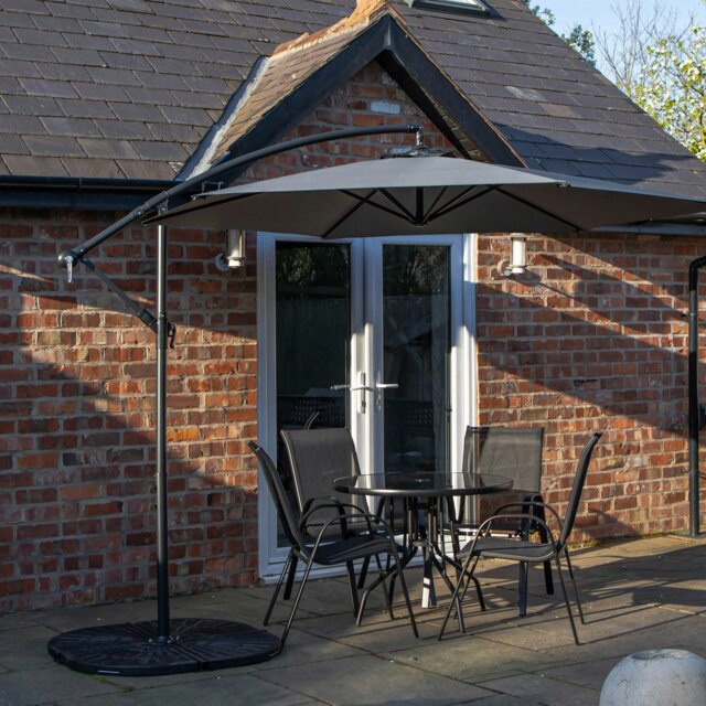 Rackhams Outdoor 4 Person Round Glass Top Garden Dining Table Chairs With Grey Banana Parasol and Base - Outdoor Furniture Sets - image 1