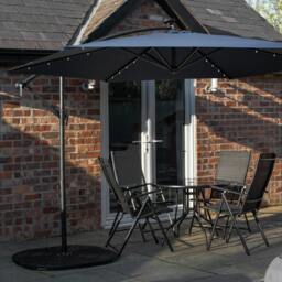 Rackhams Outdoor 4 Person Round Glass Top Garden Dining Table Chairs With Blue Banana Lit Parasol and Base Set