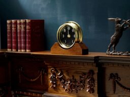Rackhams Prestige Brass Moon Phase Clock With a Jet Black Dial Mounted on Solid English Dark Oak