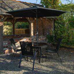 Rackhams Outdoor 4 Person Round Glass Top Garden Dining Table Chairs With Black Parasol and Base Set