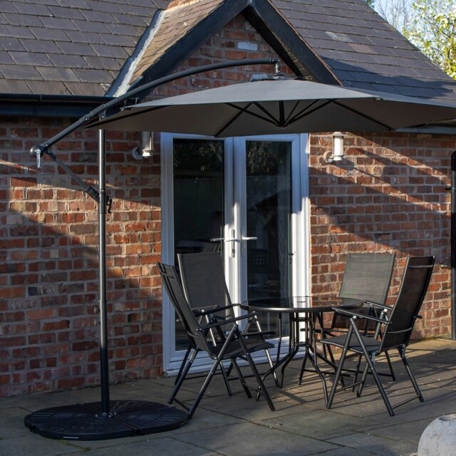 Rackhams Outdoor 4 Person Round Glass Top Garden Dining Table Chairs With Grey Banana Parasol and Base - Outdoor Furniture Sets - image 1