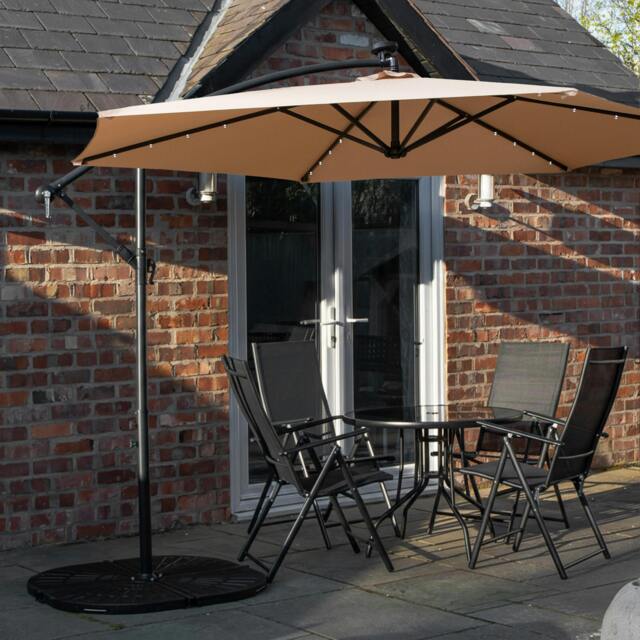 Rackhams Outdoor 4 Person Round Glass Top Garden Dining Table Chairs With Beige Banana Lit Parasol and Base Set - image 1