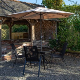 Samuel Alexander 4 Person Round Glass Top Garden Dining Set with Beige Banana Parasol - Size: 4 Seater - Black - Wilko